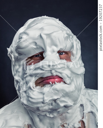 图库照片: crazy man with face completely in shaving foam