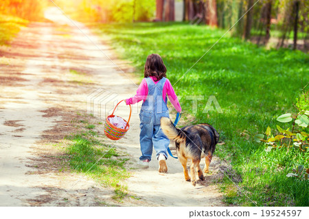 图库照片: little girl walking with dog on the road