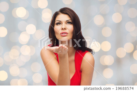 图库照片: beautiful sexy woman sending blow kiss over lights