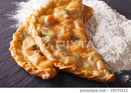 图库照片: italian pizza calzone and flour close-up on table