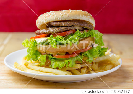 图库照片: delicious hamburger and french fries on wood table