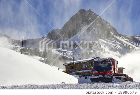 图库照片: red snow groomer in the mountain