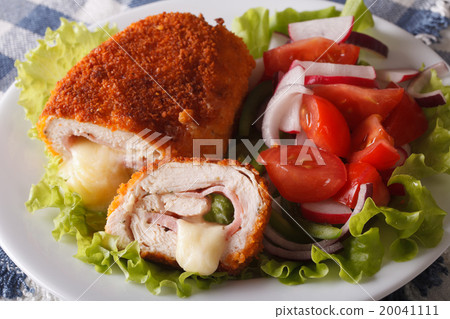 图库照片: chicken cordon bleu and vegetable salad closeup