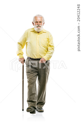 图库照片: old bearded man walking with cane