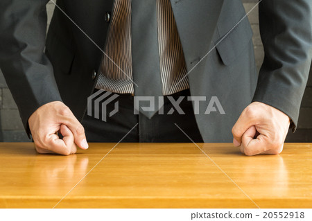 图库照片: businessman with clenched fist on the desk