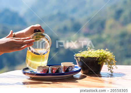 图库照片: hand holding green tea pot, concept of drinking