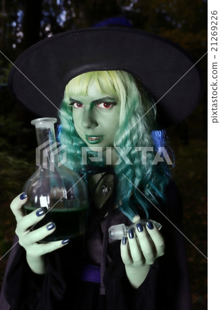 girl with green hair and flask with a potion in suit of witch in