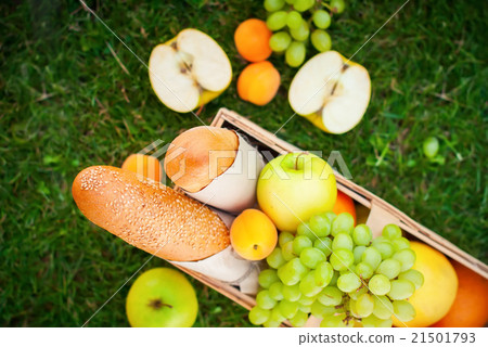 图库照片: fresh summer food fruit picnic basket apple grass