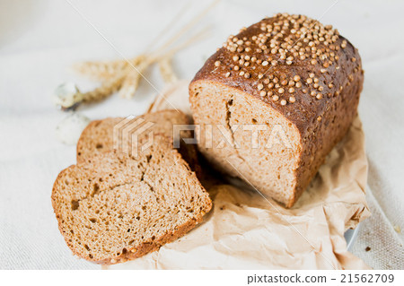 图库照片: black sliced bread with fresh coriander closeup