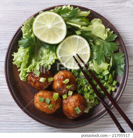 图库照片: fish balls in curry sauce with fresh herbs closeup