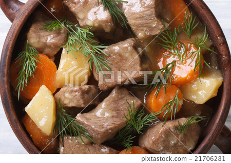 图库照片: beef stew with vegetables and herbs in a pot