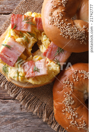 图库照片: bagel with egg and bacon close-up view from above