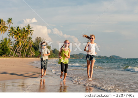 图库照片: happy children playing on the beach at the day time.