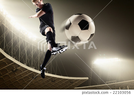 图库照片: athlete kicking soccer ball in stadium