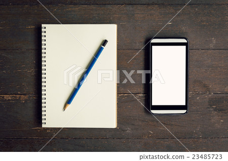 图库照片: top view above notebook and pencil with phone