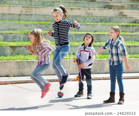 图库照片 young girl jumping while jump rope game