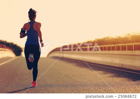 图库照片: young fitness woman runner athlete running at road