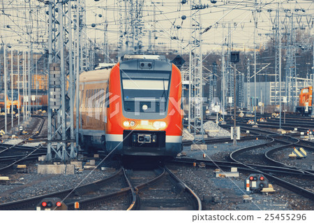 图库照片: modern orange commuter train on a railroad