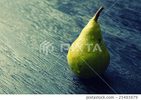 图库照片: green pear on a dark background