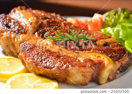 图库照片: grilled pork chop and vegetable salad,rib-eye