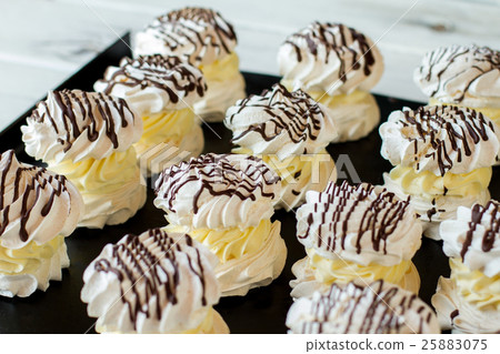 图库照片: rows of decorated meringues.