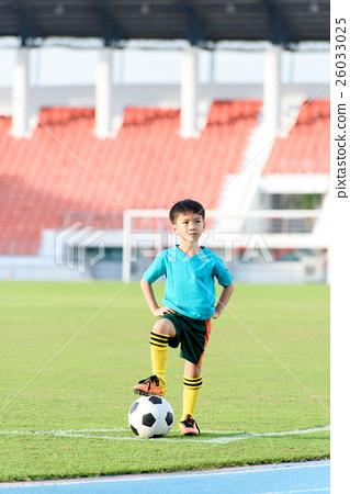 图库照片: boy and football in the football grass field