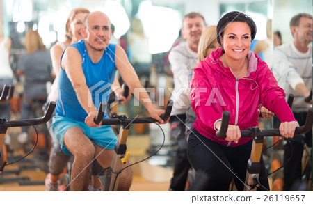 图库照片: training in sport club on fitness cycle.