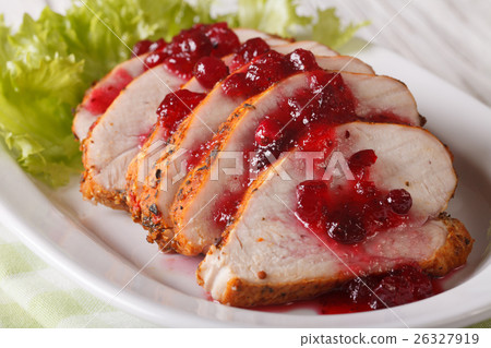 图库照片: sliced roasted turkey breast with cranberry sauce