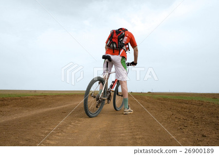 图库照片: mountain bike race on ground road in the field.