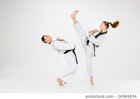 图库照片 the karate girl and boy with black belts