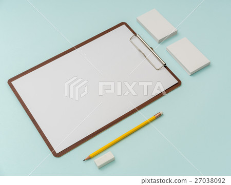 图库照片: clip board, paper,pencil and business card on blue