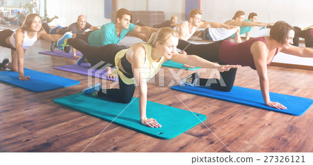 图库照片: adults having yoga class in sport club