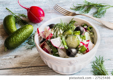 图库照片: vegan vegetable salad with fresh cucumbers, radish