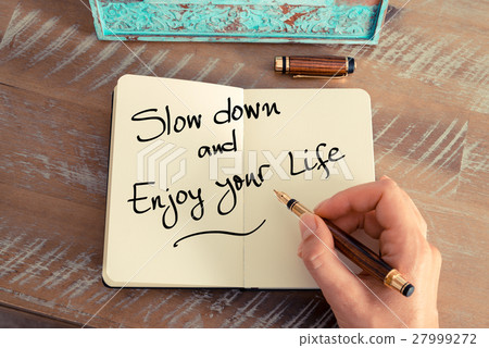 图库照片: handwritten text slow down and enjoy your life