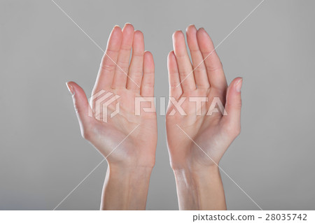 图库照片: open hands on gray background