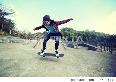 图库照片: young skateboarder riding skateboard at skatepark