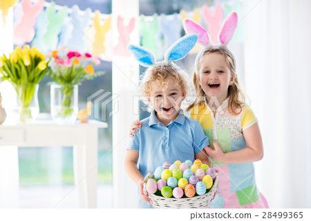 图库照片: kids with eggs basket on easter egg hunt