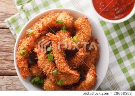 图库照片: fried shrimp in coconut breading and the sauce