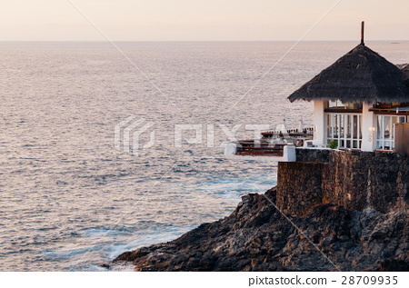 图库照片: restaurant terrace on the edge of rocky coast