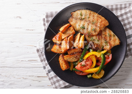 图库照片 grilled tilapia fillet and potato wedges