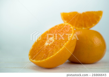 图库照片: whole orange fruit and sliced oranges on wood