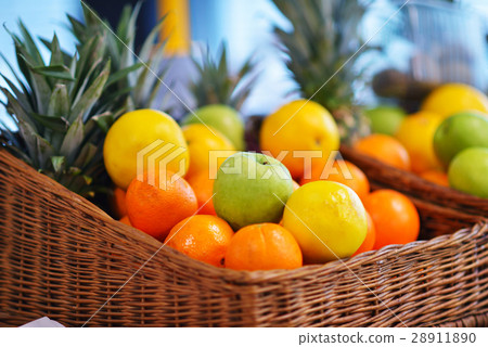 图库照片: fresh tropical fruit basket in supermarket
