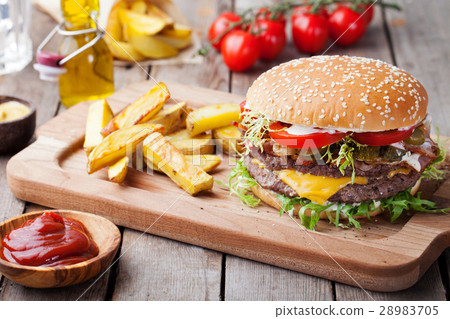 图库照片: burger, hamburger with french fries cutting board.