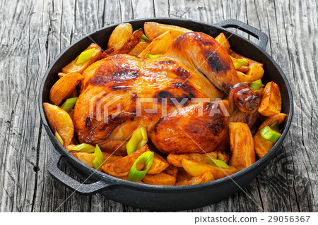 图库照片: roast chicken with fried potato wedges and leek