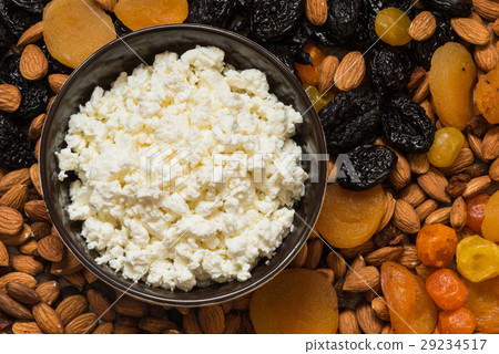 图库照片: cottage cheese in white dish. prunes, dried