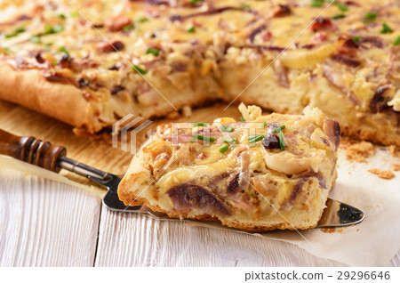 图库照片: homemade savory pie with onion, cheese and bacon.