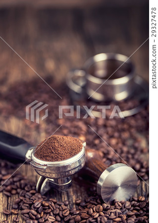 图库照片: black coffee with coffee beans and portafilter.