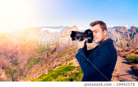 图库照片: photographer taking picture of rocky mountains