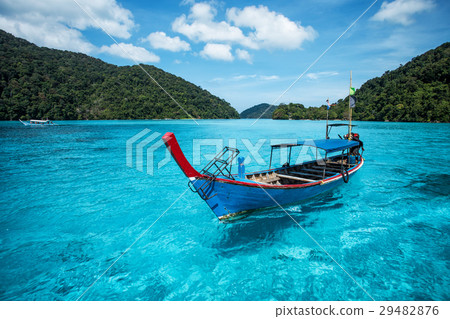 图库照片: tourist long tail boat on the sea at surin island