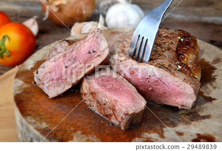 图库照片: medium rare beef steak grill.